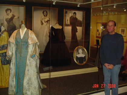 Charles Triplett stand in front of one of the displays at the Ava Gardner Museum.